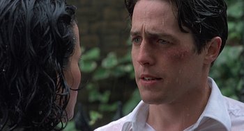 Movie still from “Four Weddings and a Funeral” (1994), directed by Mike Newell – A man and a woman looking at one another; Close Up shot, Over the shoulder angle