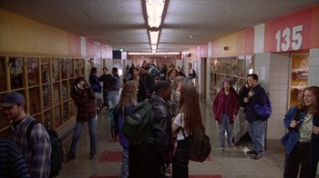 Movie still from “Foxfire” (1996), directed by Annette Haywood-Carter – A group of people standing in a hallway of a building; Wide shot, High angle