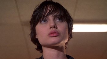 Movie still from “Foxfire” (1996), directed by Annette Haywood-Carter – A person with short hair; Close Up shot, Low angle