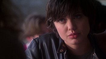 Movie still from “Foxfire” (1996), directed by Annette Haywood-Carter – A person wearing a leather jacket; Close Up shot, Over the shoulder angle