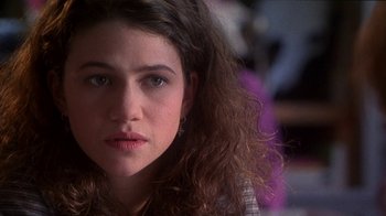 Movie still from “Foxfire” (1996), directed by Annette Haywood-Carter – A person with long curly hair; Close Up shot, Over the shoulder angle