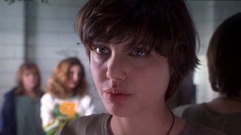 Movie still from “Foxfire” (1996), directed by Annette Haywood-Carter – A person with short brown hair; Close Up shot, Low angle