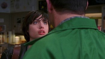 Movie still from “Foxfire” (1996), directed by Annette Haywood-Carter – A woman looking at a man in a green jacket; Close Up shot, Over the shoulder angle