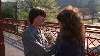 Movie still from “Foxfire” (1996), directed by Annette Haywood-Carter – Two young people standing next to each other on a bridge; Medium shot, Over the shoulder angle