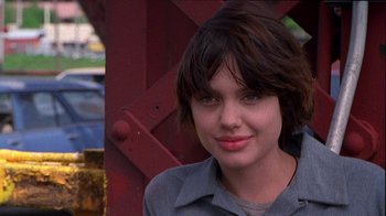 Movie still from “Foxfire” (1996), directed by Annette Haywood-Carter – A person with short brown hair; Close Up shot, Over the shoulder angle