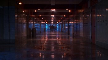 Movie still from “Foxfire” (1996), directed by Annette Haywood-Carter – People are walking in a dark hallway at night; Extreme Wide shot, High angle