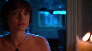 Movie still from “Foxfire” (1996), directed by Annette Haywood-Carter – A woman with a necklace sitting in front of a window; Close Up shot, Over the shoulder angle