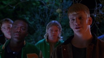 Movie still from “Foxfire” (1996), directed by Annette Haywood-Carter – A group of young men standing next to each other; Medium shot, Low angle