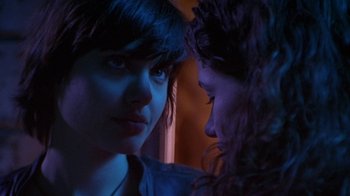 Movie still from “Foxfire” (1996), directed by Annette Haywood-Carter – Two women looking at one another in a dark room; Close Up shot, Over the shoulder angle
