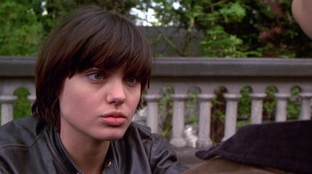 Movie still from “Foxfire” (1996), directed by Annette Haywood-Carter – A woman with bangs and a black leather jacket; Close Up shot, Over the shoulder angle