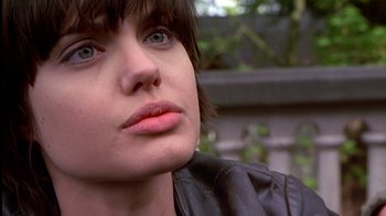 Movie still from “Foxfire” (1996), directed by Annette Haywood-Carter – A person wearing a leather jacket; Close Up shot, Over the shoulder angle