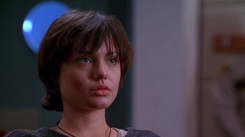 Movie still from “Foxfire” (1996), directed by Annette Haywood-Carter – A person with short brown hair; Close Up shot, Over the shoulder angle