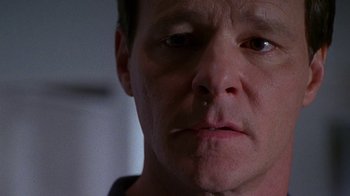 Movie still from “Foxfire” (1996), directed by Annette Haywood-Carter – A man's face in a dark room; Close Up shot, Low angle