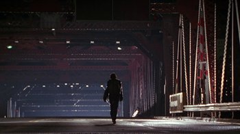 Movie still from “Foxfire” (1996), directed by Annette Haywood-Carter – A person is walking down a street at night; Wide shot, Low angle