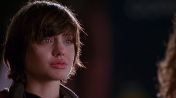 Movie still from “Foxfire” (1996), directed by Annette Haywood-Carter – A person with short brown hair; Close Up shot, Over the shoulder angle