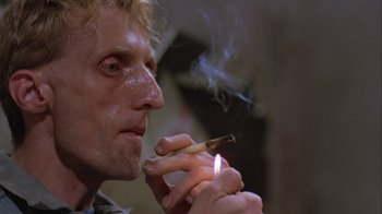 A person holding a lit cigarette