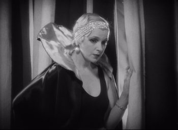 Movie still from “Freaks” (1932), directed by Tod Browning – A black and white photo of a woman wearing a headpiece; Close Up shot, Low angle