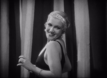 Movie still from “Freaks” (1932), directed by Tod Browning – A black and white photo of a woman in a bathing suit; Close Up shot, Low angle