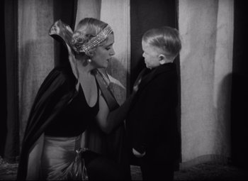Movie still from “Freaks” (1932), directed by Tod Browning – A woman and a boy in a black and white photo; Medium shot, High angle