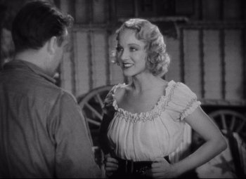 Movie still from “Freaks” (1932), directed by Tod Browning – An old photo of a man and a woman talking; Medium shot, Over the shoulder angle