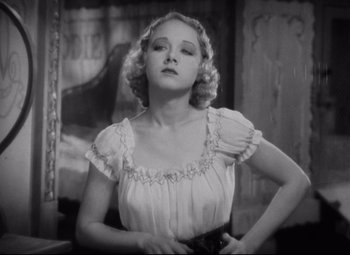 Movie still from “Freaks” (1932), directed by Tod Browning – A woman in a white dress is posing for a picture; Close Up shot, Low angle