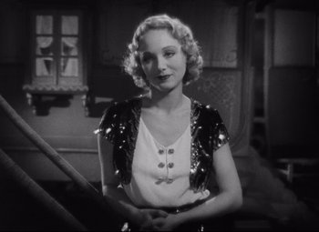 Movie still from “Freaks” (1932), directed by Tod Browning – A black and white photo of a woman in a sequined vest; Medium shot, Over the shoulder angle