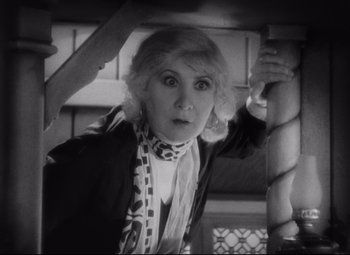 Movie still from “Freaks” (1932), directed by Tod Browning – An old photo of a woman with a scarf around her neck; Close Up shot, High angle