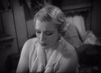 Movie still from “Freaks” (1932), directed by Tod Browning – An old photo of a woman looking down at her face; Close Up shot, High angle
