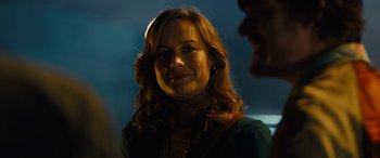 Movie still from “Free Fire” (2016), directed by Ben Wheatley – A person wearing a green shirt; Close Up shot, Over the shoulder angle