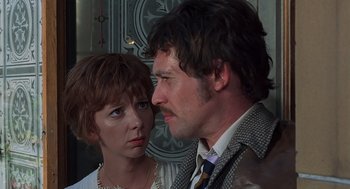 Movie still from “Frenzy” (1972), directed by Alfred Hitchcock – A man and a woman standing next to each other; Close Up shot, Low angle