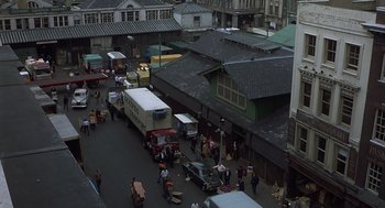 Movie still from “Frenzy” (1972), directed by Alfred Hitchcock – An aerial view of a street with many cars parked on the side of the street; Extreme Wide shot, Overhead angle