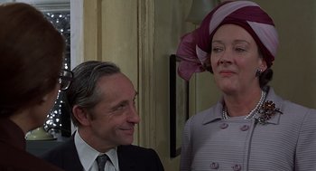 Movie still from “Frenzy” (1972), directed by Alfred Hitchcock – A man and a woman wearing suits and hats; Close Up shot, Low angle