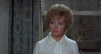 Movie still from “Frenzy” (1972), directed by Alfred Hitchcock – A person wearing a suit and tie; Close Up shot, Over the shoulder angle