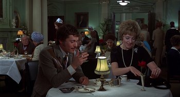 Movie still from “Frenzy” (1972), directed by Alfred Hitchcock – A man and a woman sitting at a dinner table; Medium shot, Over the shoulder angle