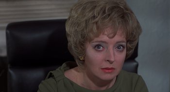 Movie still from “Frenzy” (1972), directed by Alfred Hitchcock – A person wearing a green shirt; Close Up shot, Over the shoulder angle
