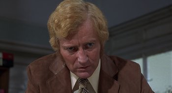 Movie still from “Frenzy” (1972), directed by Alfred Hitchcock – A person wearing a suit and tie; Close Up shot, High angle