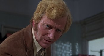 Movie still from “Frenzy” (1972), directed by Alfred Hitchcock – A person wearing a suit and tie; Close Up shot, Low angle