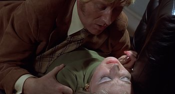 Movie still from “Frenzy” (1972), directed by Alfred Hitchcock – A man and a woman laying on the ground; Close Up shot, High angle