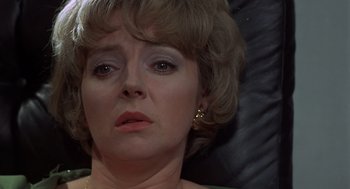 Movie still from “Frenzy” (1972), directed by Alfred Hitchcock – A woman's face as she stares into the distance; Close Up shot, High angle