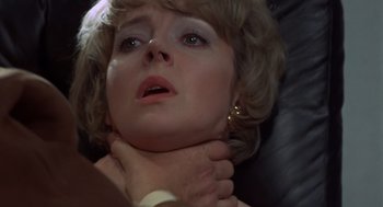 Movie still from “Frenzy” (1972), directed by Alfred Hitchcock – A person with their hands on her neck; Close Up shot, Overhead angle