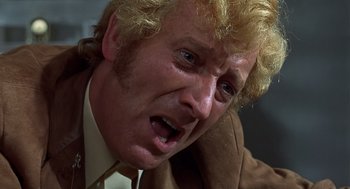 Movie still from “Frenzy” (1972), directed by Alfred Hitchcock – A person wearing a suit and tie; Close Up shot, Low angle