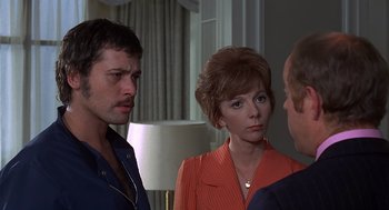 Movie still from “Frenzy” (1972), directed by Alfred Hitchcock – Two men and a woman are talking to each other; Close Up shot, Over the shoulder angle