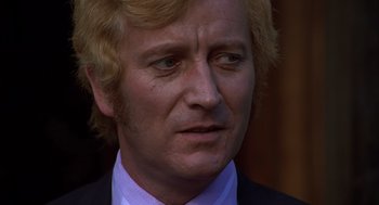 Movie still from “Frenzy” (1972), directed by Alfred Hitchcock – A person wearing a suit and tie; Close Up shot, Low angle