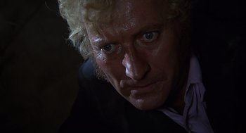 Movie still from “Frenzy” (1972), directed by Alfred Hitchcock – A man's face in the dark; Close Up shot, Low angle