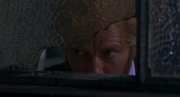 Movie still from “Frenzy” (1972), directed by Alfred Hitchcock – A person looking through a window; Extreme Close Up shot, Low angle