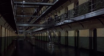Movie still from “Frenzy” (1972), directed by Alfred Hitchcock – Two men are standing on a set of stairs in a building; Extreme Wide shot, High angle