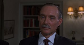 Movie still from “Frenzy” (1972), directed by Alfred Hitchcock – A person wearing a suit and tie; Close Up shot, High angle