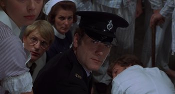 Movie still from “Frenzy” (1972), directed by Alfred Hitchcock – A person wearing a uniform; Close Up shot, Low angle