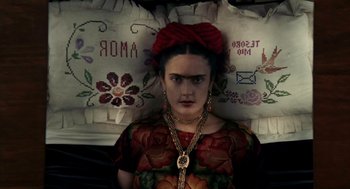 Movie still from “Frida” (2002), directed by Julie Taymor – A woman with a red bow on her head; Close Up shot, Overhead angle