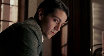 Movie still from “Frida” (2002), directed by Julie Taymor – A man in a suit looking to his left; Close Up shot, Low angle